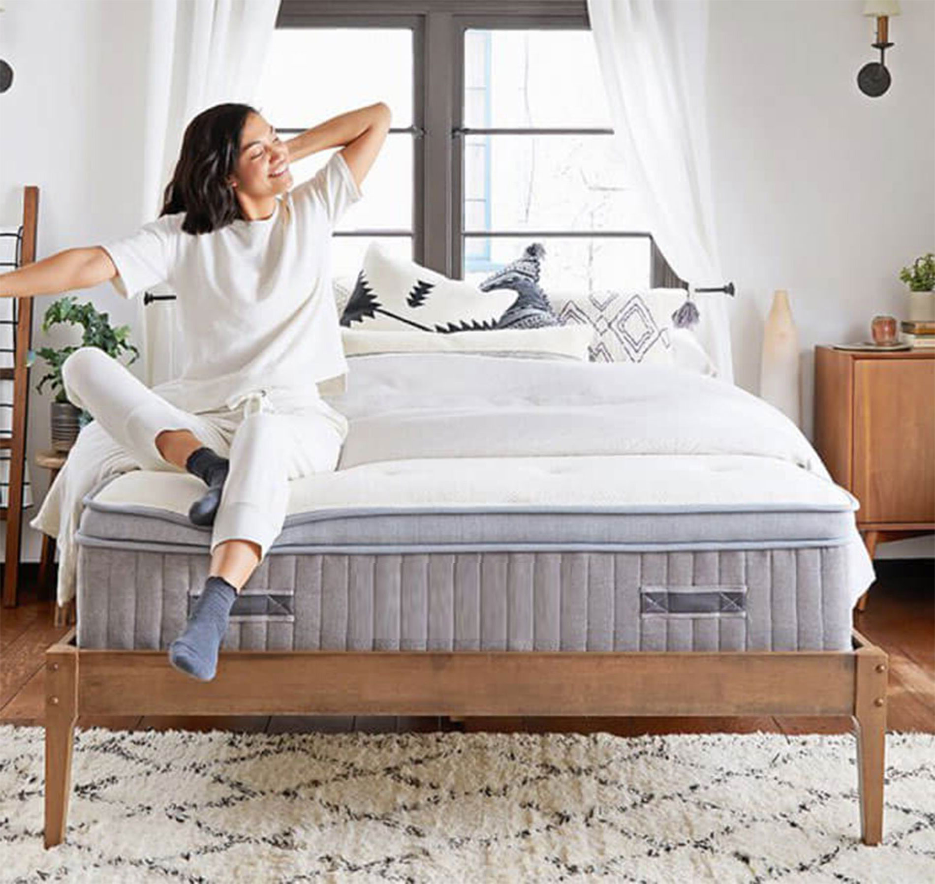 Woman waking up on a Universal Mattress in a bright Chennai bedroom
